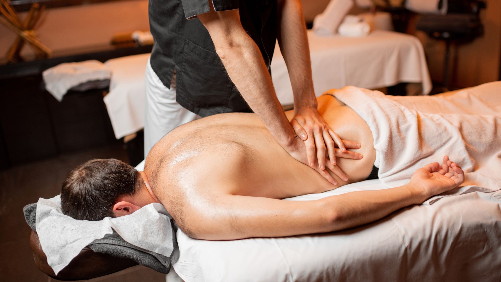 A man getting a back massage at a spa